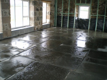 Laying of new Caithness Flagstone floor as part of barn renovation at Forsanain